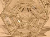 a glass vase that has a small glass object inside of it