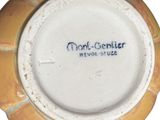 a yellow and white plate with a blue writing on it
