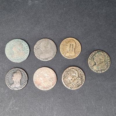 six types de pièces différents sur une surface noire