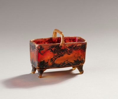 a red and black bowl with a handle on it