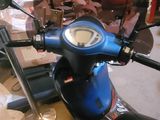 a blue motorcycle that is parked in a garage