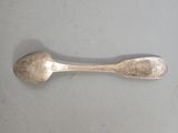 a silver spoon and a silver spoon on a table