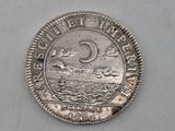 a close up of a coin on a white surface