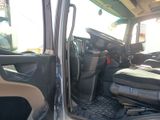a view of the inside of a truck from the driver ' s seat