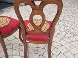 two chairs that are sitting next to each other on the sidewalk