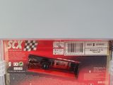 the back of a red box with a black and white car in it