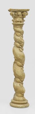 a tall gold vase with a spiral design on it