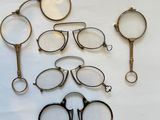 a lot of glasses and a magnifying glass on the table