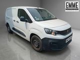 the white van is parked in a large room with a grey floor