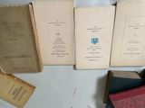 several old books sitting on top of a table next to each other