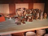 a table with a lot of silver dishes and cups on it