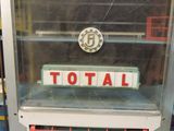 a glass case with a sign that says total