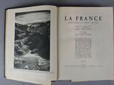 an open book with a black and white photo of mountains in the background