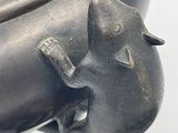 a close up of a metal object with a cat on it ' s head