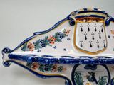 a blue and white bowl with a coat of arms on it