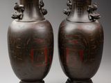 pair of antique chinese vases with red and black designs on them