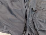 the back of a jacket with a zippered pocket on it