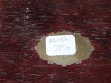 a label on a piece of wood with a sticker on it