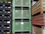 many crates stacked on top of each other in a warehouse