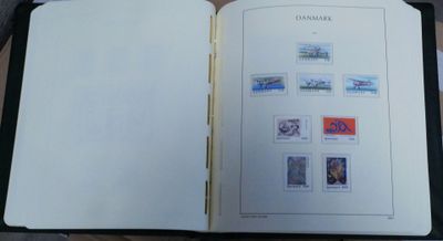 an open book with stamps on it sitting on a table