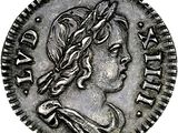 a silver coin with a woman ' s head on it