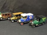 five toy cars that are lined up on a black surface