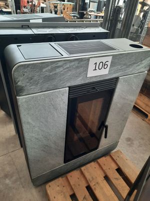 lot of three steel stoves in a warehouse with a price tag on the front