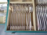 a lot of silverware in a box on a table