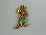 a close up of a gold and turquoise broochle broochle