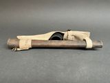 a wooden stick with a roll of fabric on it