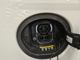 an electric car plugged in to a charging station with a charger