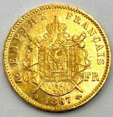 a close up of a gold coin on a white surface