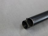 a close up of a black pipe on a white surface