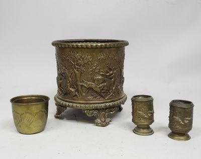 three brass vases and a cup on a white background