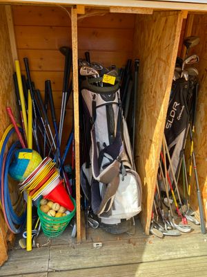 a wooden shed with a bunch of different items in it