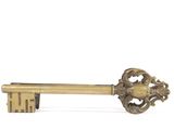 a gold key that is sitting on top of a table