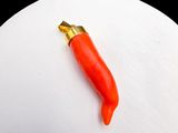 un poivron rouge posé sur un œuf blanc