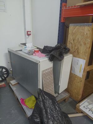 an image of a room with a microwave and a trash bag
