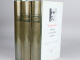 three books sitting on top of each other on a white surface