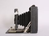 a black camera that is sitting on top of a piece of paper