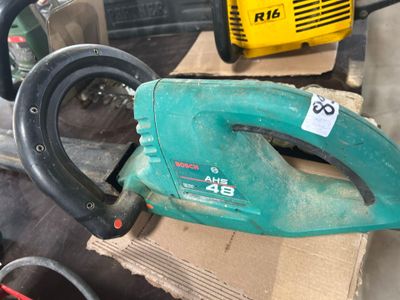 a green and black corded blower sitting on top of a cardboard box