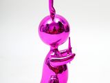 a shiny pink sculpture of a person holding a cell phone