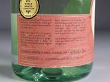 a bottle of green liquid with a label on it