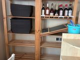 a shelf with bottles of wine on it in a kitchen