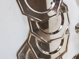 a silver plate and a silver cup on a white table