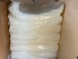 a lot of bags of toilet paper on the shelf