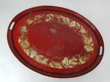 an image of a red tray with gold leaf designs on it