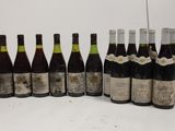 several bottles of wine are lined up in a row on a table
