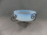 a blue bowl on a stand on a white background