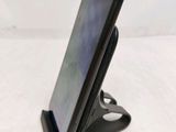 a cell phone that is sitting on top of a stand
